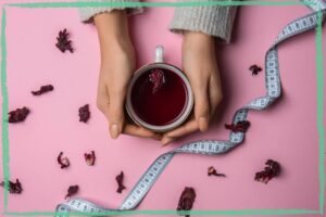 Female hands holding a cup of herbal fruit tea, indicating an article on herbal tea for weight loss by BalkanHerb