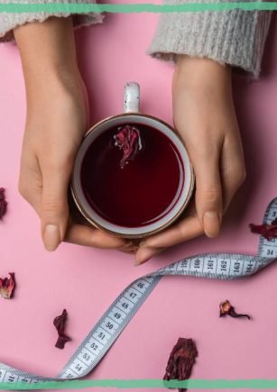 Female hands holding a cup of herbal fruit tea, indicating an article on herbal tea for weight loss by BalkanHerb